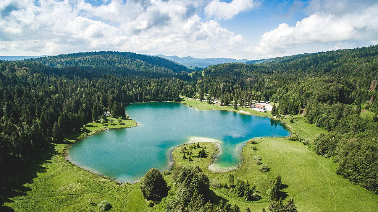 Lac de montagne dans l'Ain entouré de forêts