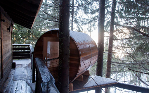 Vue sur une cabane entre ciel et terre au milieu de la montagne entre les arbres