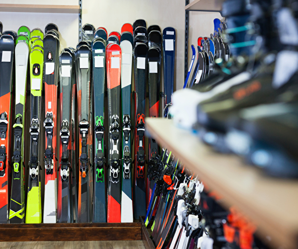 Magasin de location de matériel de skis avec skis alignés contre le mur